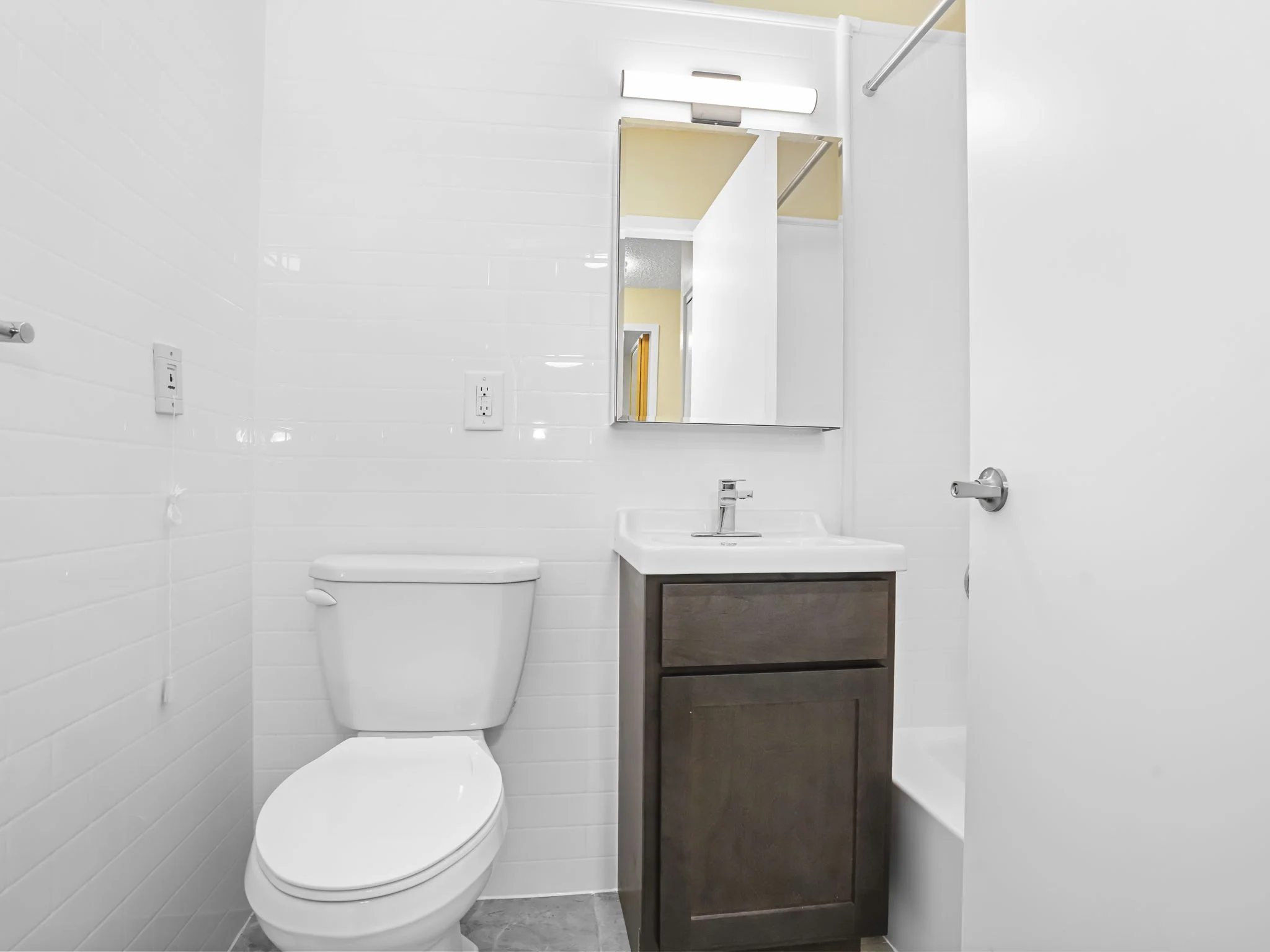 Completed Tindel bathroom with a white wall system, vanity and toilet
